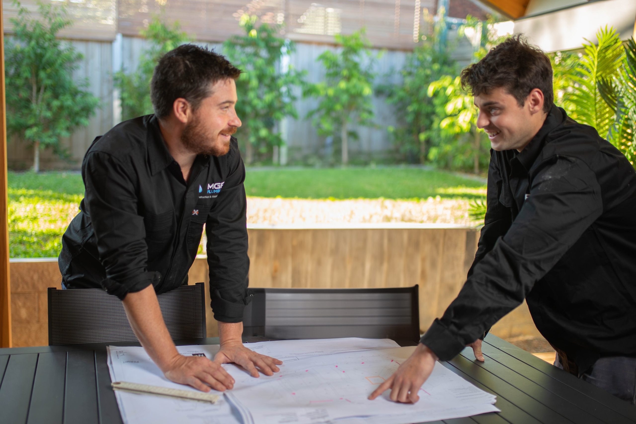 image of 2 plumbers working on a table